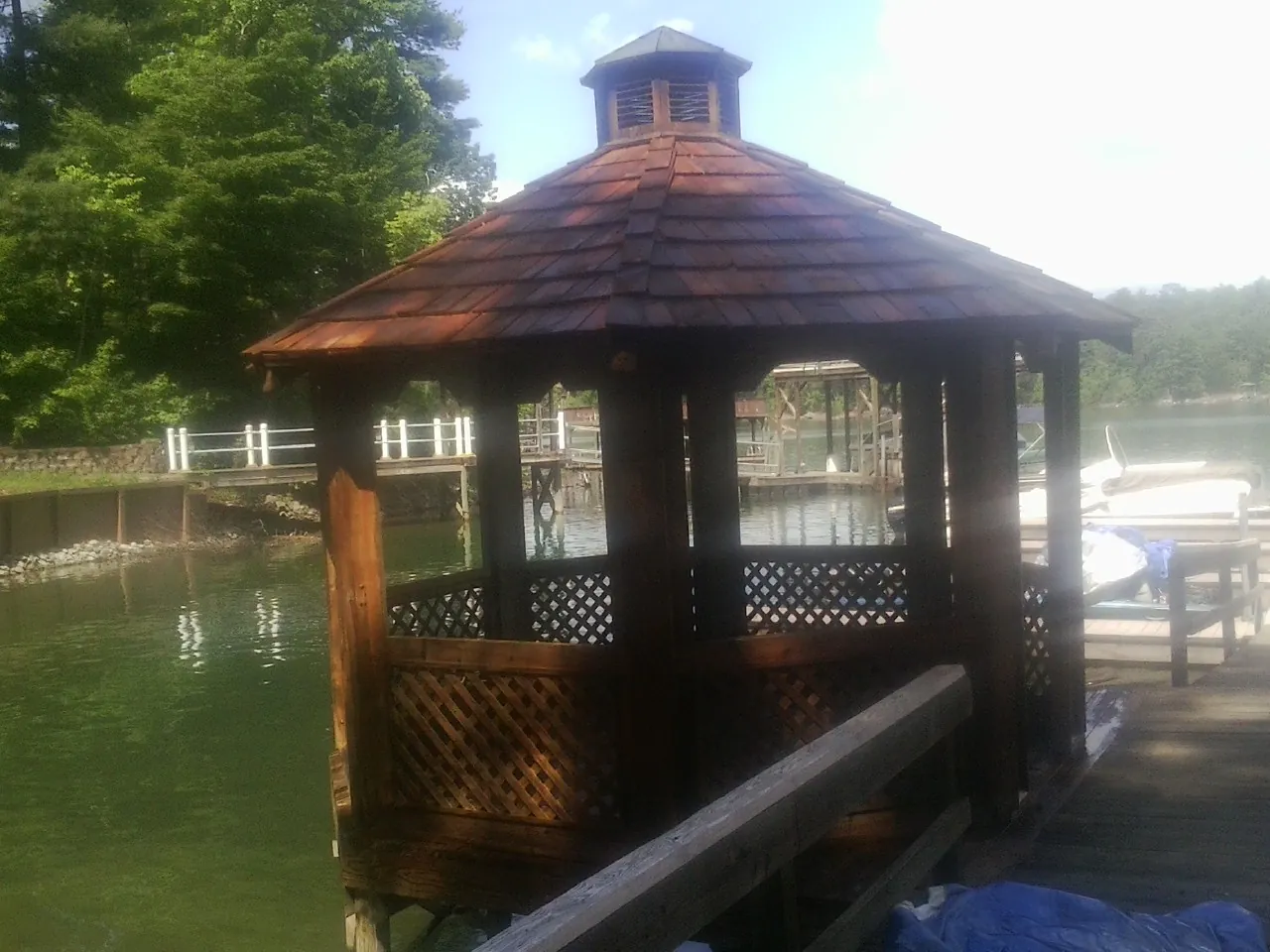 Cedar shake gazebo roof rebuilt on a lake dock in Pulaski