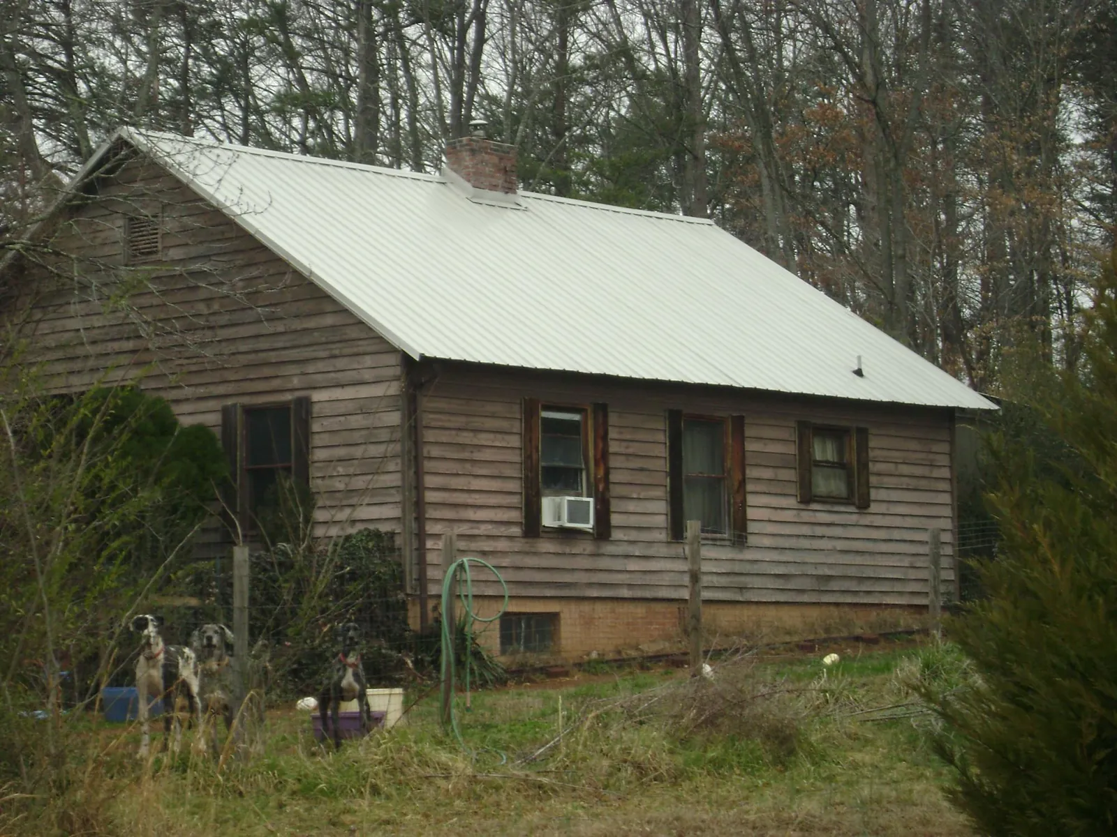 White metal roof on an old wood sided farmhouse, from a Metal Roof Installation job in Pulaski